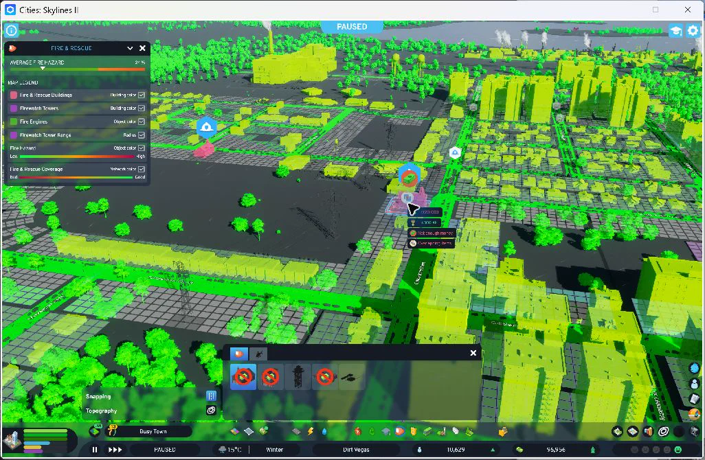 18:23 — Fire coverage overlay around the western addition. The retained tool preview overlaps the new facility and displays a warning; no duplicate was built. Final checks confirmed twelve staff and available fire engines. The overlay alone does not prove response times.