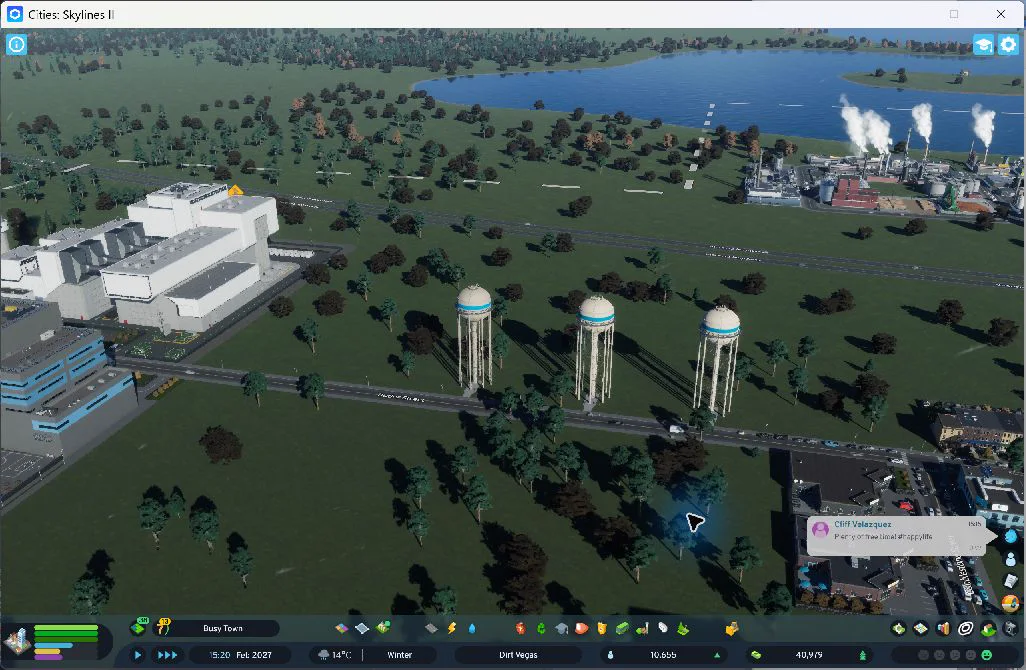18:24 — All three new water towers now stand along the approach. The incinerator is at left, the prison is partly visible at the lower-left edge, and the existing coal plant is beyond the highway. This was captured during the final simulation, before the final saved figures. A clear full-building prison portrait is still missing.