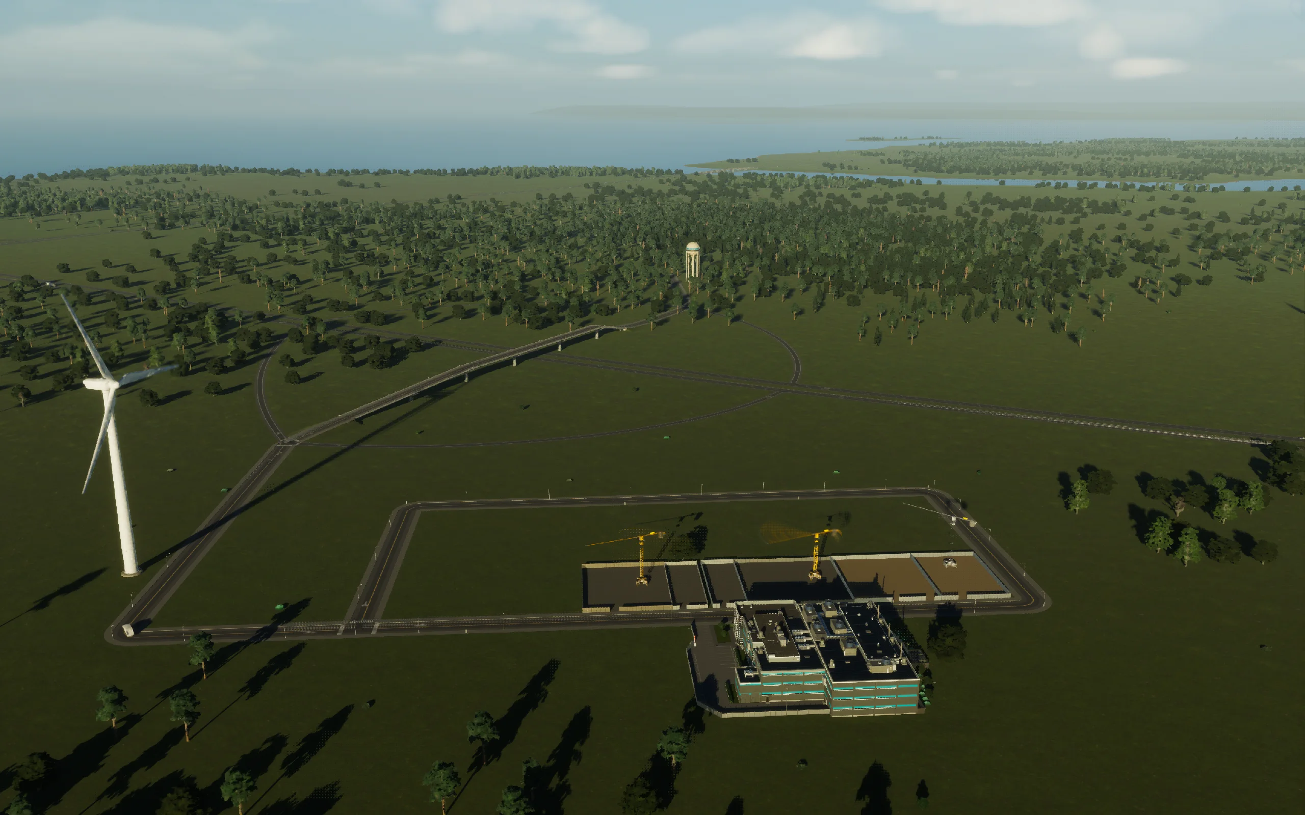 The first factories under construction, with the treatment plant, turbine, crossing and distant water tower already in place.